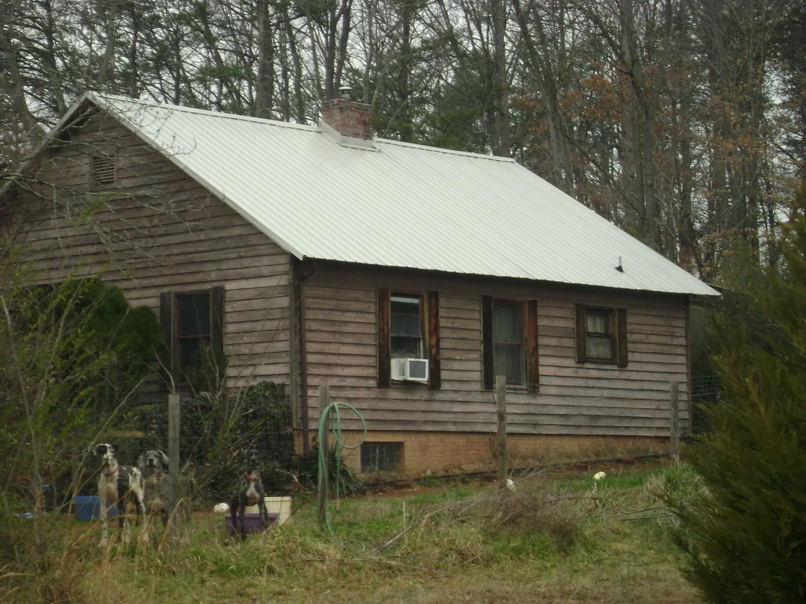 White metal roof on an old wood sided farmhouse, from a Metal Roof Installation job in Mount Upton